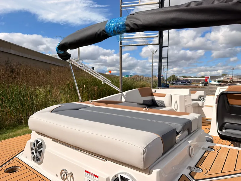 Slide: The Image of The image shows the deck of a 2027 Starcraft 211SVXIO boat with cushioned seating. - 15