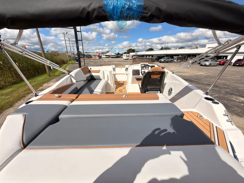 Slide: The Image of The image shows the deck of a 2027 Starcraft 211SVXIO boat with gray and brown upholstery. - 11
