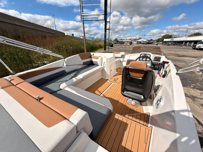 Slide: The Image of The image shows a 2027 Starcraft 211SVXIO boat with sleek seating and a modern helm. - 20