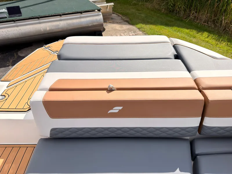 Slide: The Image of The image shows the cushioned seating of a 2027 Starcraft 211SVXIO boat. - 23