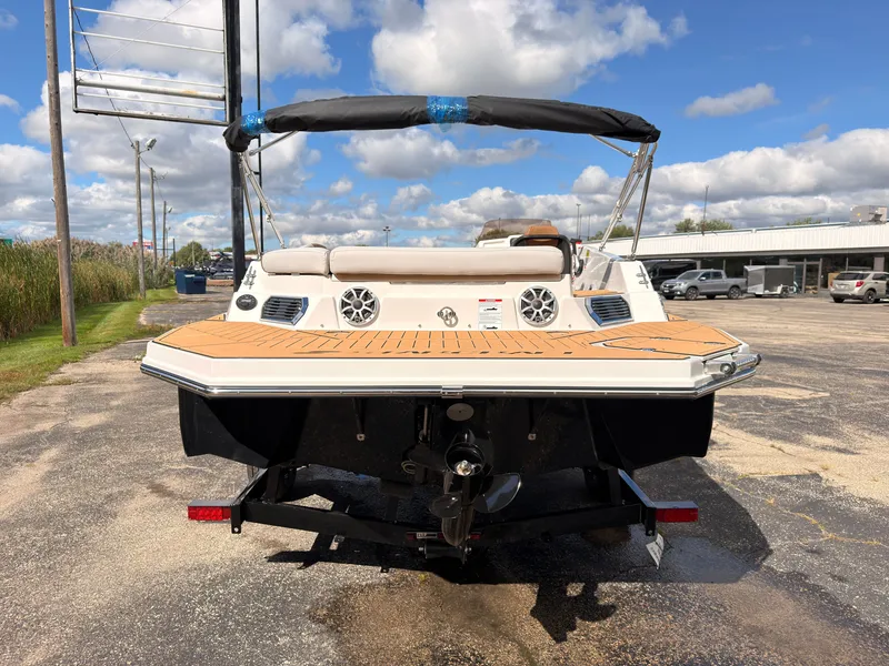Slide: The Image of The image shows a 2027 Starcraft 211SVXIO boat with a black hull and spacious deck. - 6