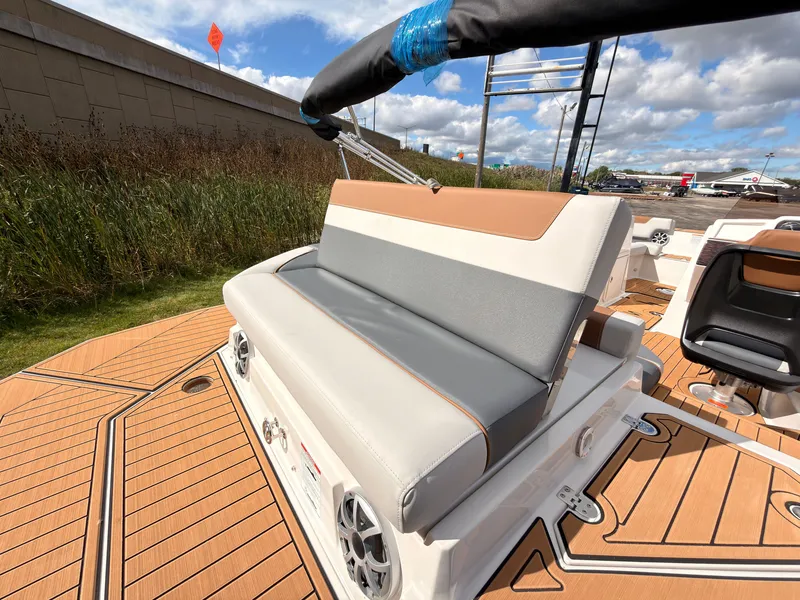 Slide: The Image of The image shows a modern boat seat with gray and white upholstery on a wooden deck. - 17