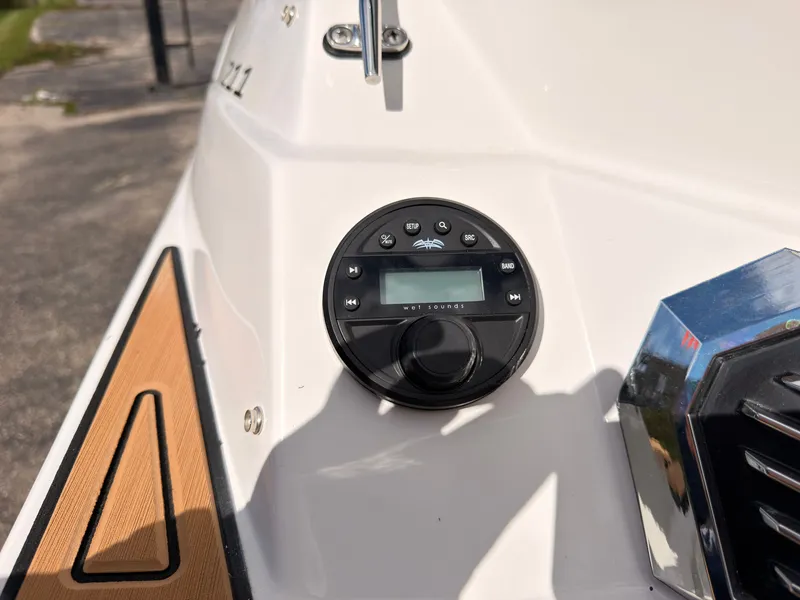 Slide: The Image of A modern audio system is integrated into the white boat, featuring a sleek control panel and wood accents. - 14