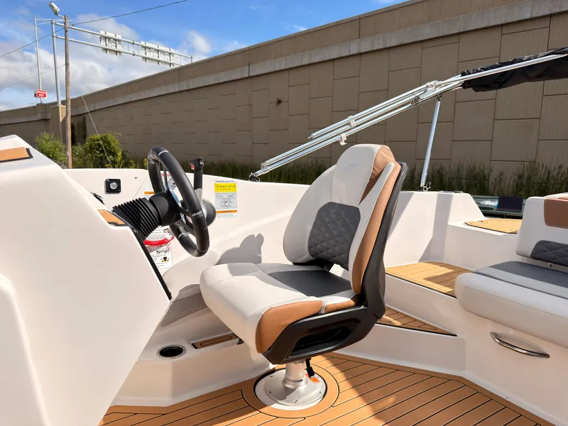 Slide: The Image of The image shows the helm of a 2027 Starcraft 211SVXIO with a cushioned seat. - 36