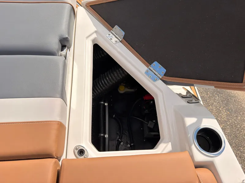 Slide: The Image of An open storage compartment on a boat with brown and gray upholstery. - 27