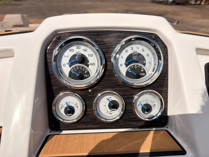 Slide: The Image of The image shows the dashboard of a Starcraft 211SVXIO boat with various gauges and instruments. - 40