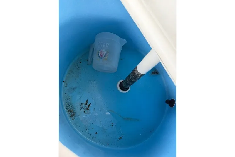 Slide: The Image of Livewell interior of 2019 Carolina Skiff 24 DLX with measuring jug and water. - 13