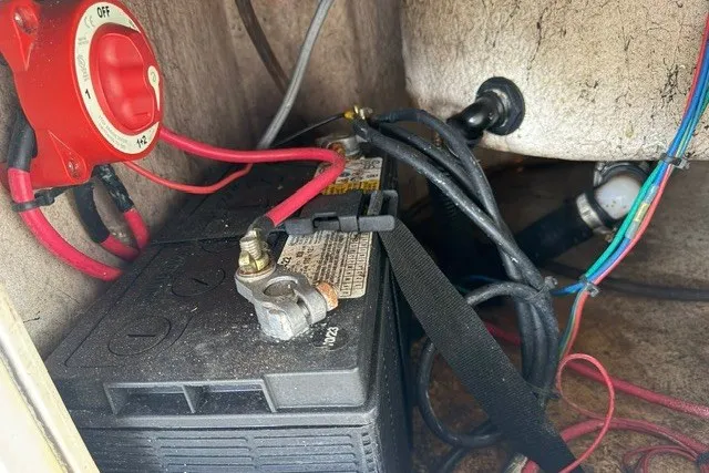 Slide: The Image of Battery compartment of a 2019 Carolina Skiff 24 DLX with wiring and switch. - 20