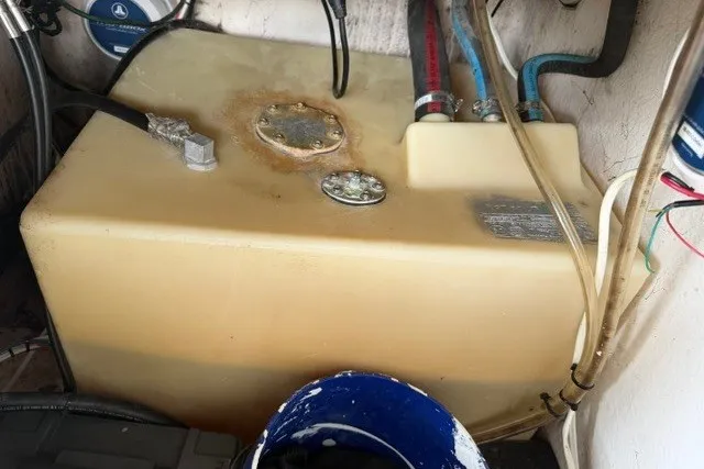 Slide: The Image of Fuel tank of a 2019 Carolina Skiff 24 DLX boat, showing hoses and connections. - 22