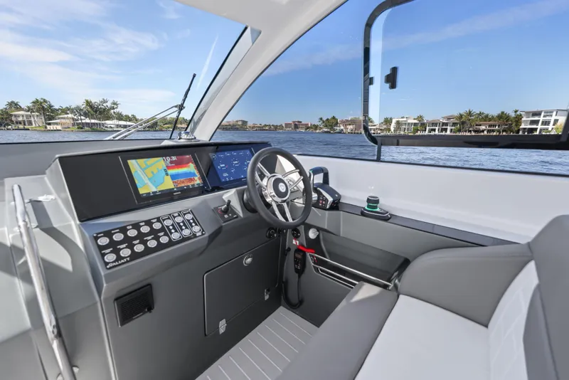 Slide: The Image of 2025 Valiatt 380 Bowrider cockpit with modern controls and waterfront view. - 8