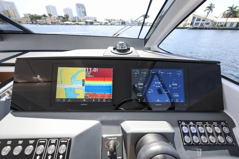 Slide: The Image of Dashboard of 2025 Valiatt 380 Bowrider with Garmin navigation displays on water. - 9