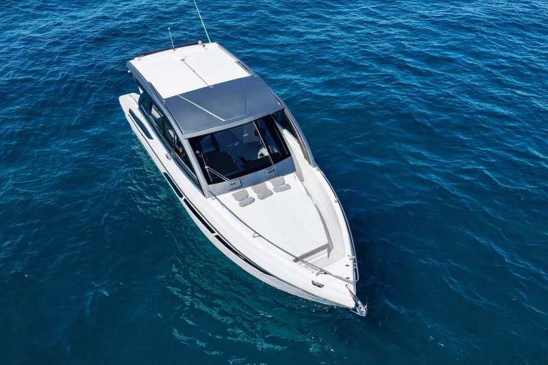 Slide: The Image of 2025 VALIATT YACHTS 380 Bowrider cruising on clear blue water. - 8