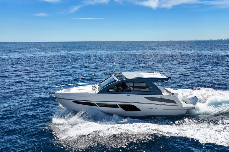 Slide: The Image of 2025 VALIATT YACHTS 380 Bowrider cruising on open sea under clear blue sky. - 3