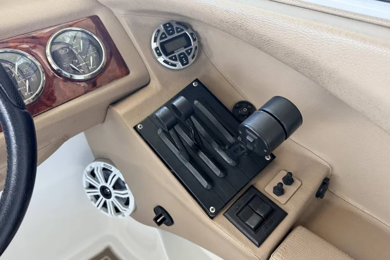 Slide: The Image of 2008 Cobalt 282 boat dashboard with gauges, controls, and speaker. - 22