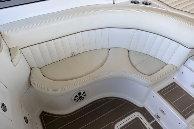 Slide: The Image of 2008 Cobalt 282 boat interior with white leather seating and cup holders. - 13