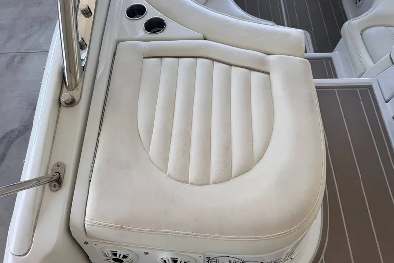 Slide: The Image of 2008 Cobalt 282 boat seat with white upholstery and cup holders. - 10