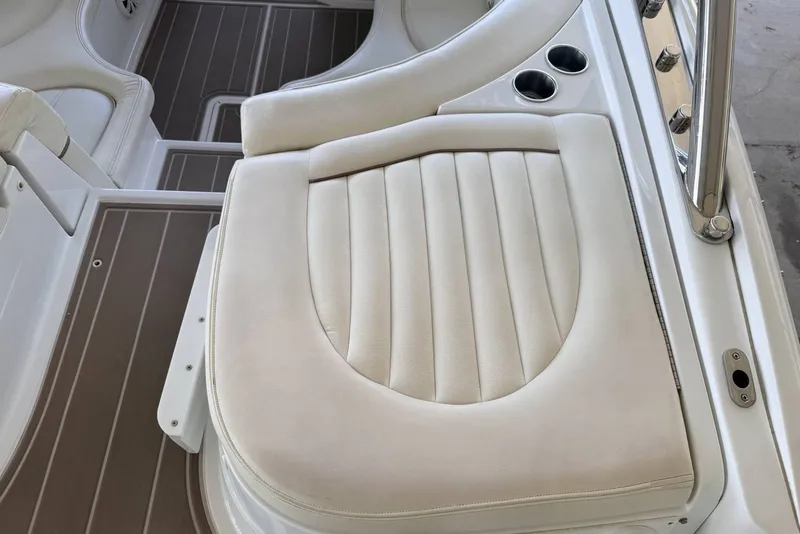 Slide: The Image of 2008 Cobalt 282 boat interior with white cushioned seating and cup holders. - 11
