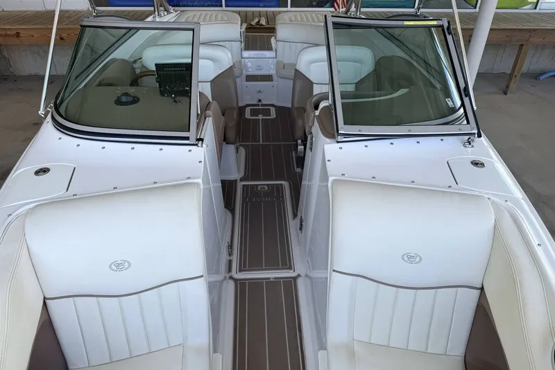 Slide: The Image of 2008 Cobalt 282 boat interior with white seating and open windshield. - 19