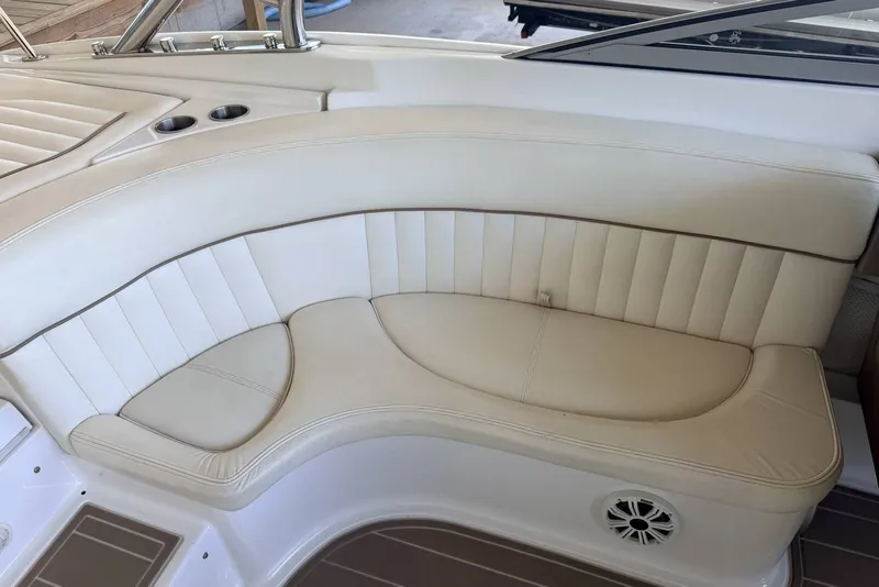 Slide: The Image of Cream leather seating on a 2008 Cobalt 282 boat, featuring cup holders and speaker. - 14