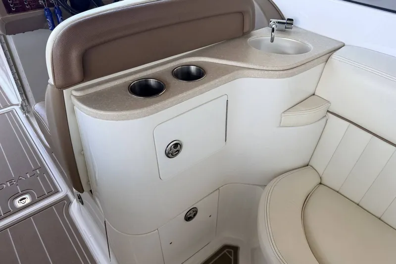 Slide: The Image of Interior of a 2008 Cobalt 282 boat featuring a sink and cup holders. - 18
