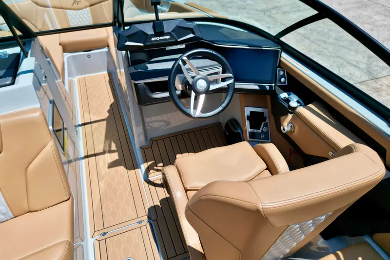 Slide: The Image of Luxurious interior of 2026 MasterCraft XT24 boat with tan leather seating and modern dashboard. - 8