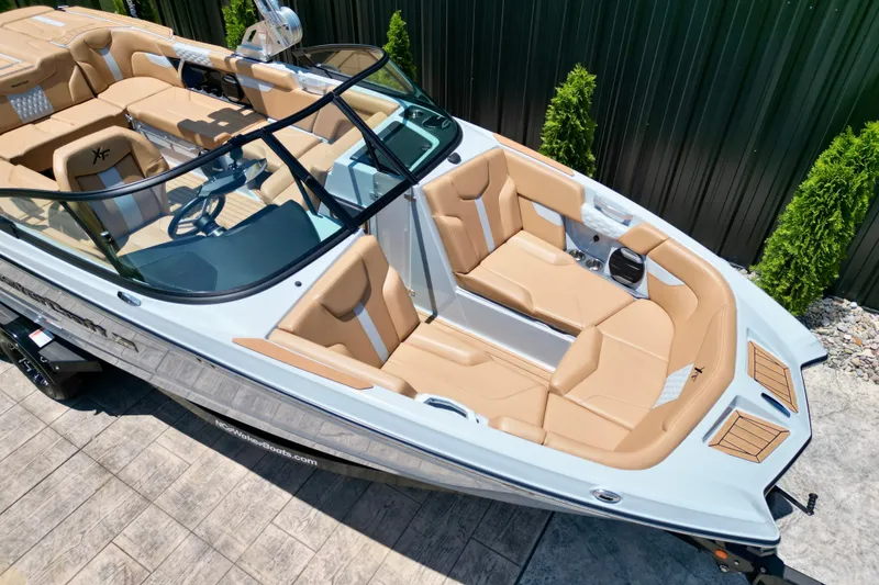 Slide: The Image of 2026 MasterCraft XT24 boat with luxurious tan seating and sleek design. - 16