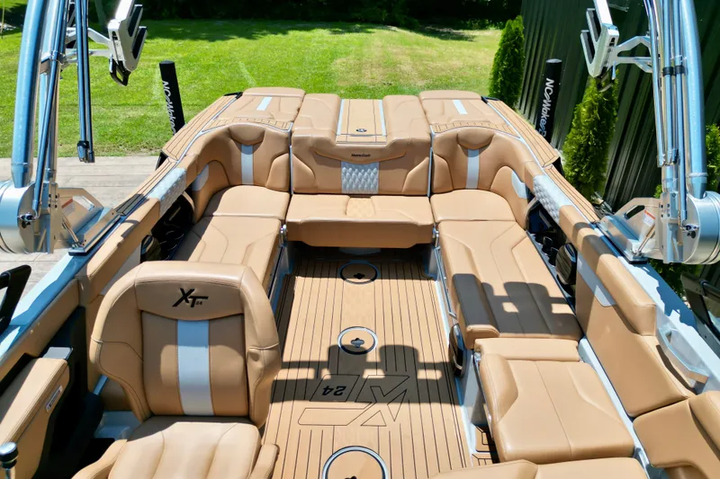 Slide: The Image of 2026 MasterCraft XT24 boat interior with tan leather seating and sleek design. - 14