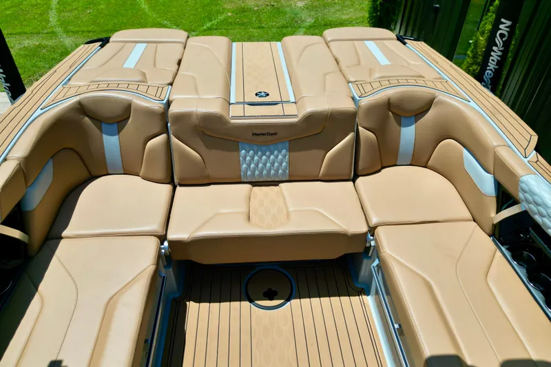 Slide: The Image of 2026 MasterCraft XT24 boat interior with luxurious tan seating and sleek design. - 5