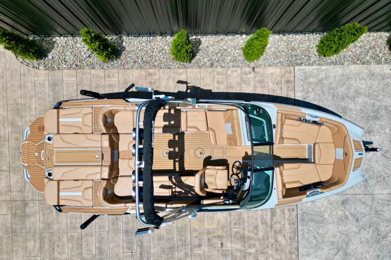 Slide: The Image of Overhead view of 2026 MasterCraft XT24 boat with tan interior and sleek design. - 12