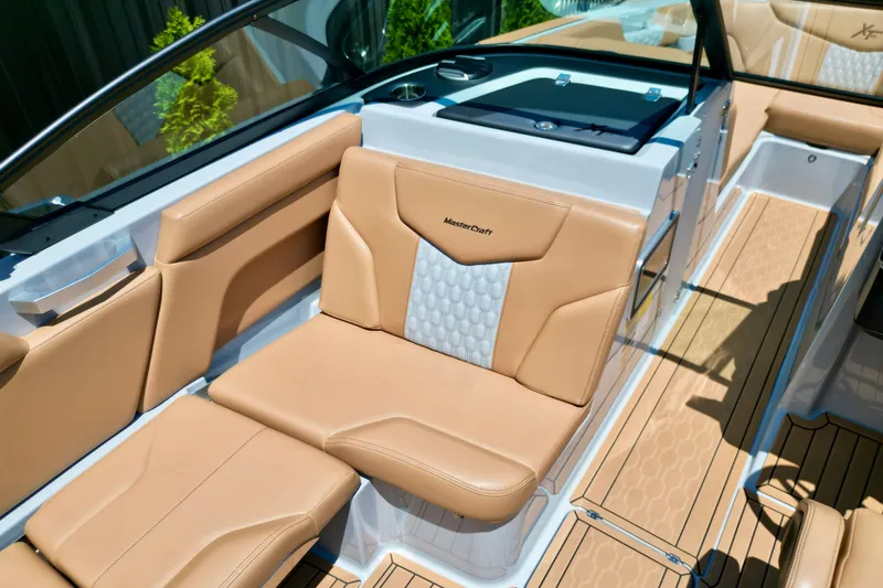 Slide: The Image of 2026 MasterCraft XT24 boat interior with tan leather seating and modern design. - 6