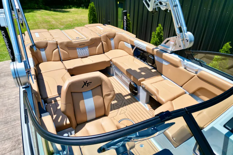 Slide: The Image of 2026 MasterCraft XT24 boat interior with luxurious tan seating and modern design. - 15