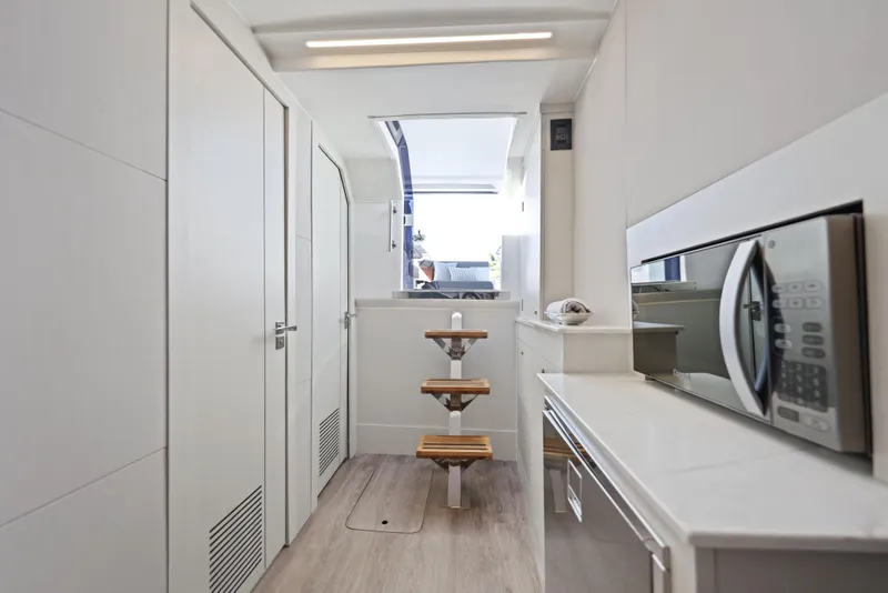 Slide: The Image of Interior of 2025 Valiatt 380 Bowrider boat with modern kitchen and wooden steps. - 19