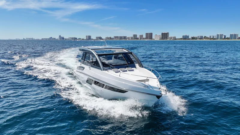 Slide: The Image of 2025 Valiatt 380 Bowrider cruising on ocean near city skyline. - 1
