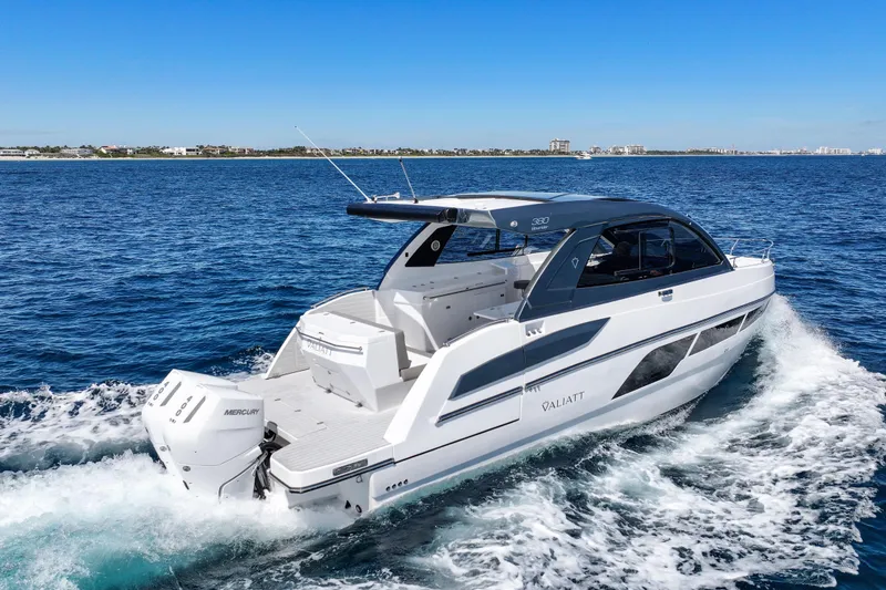 Slide: The Image of 2025 VALIATT YACHTS 380 Bowrider cruising on open water under clear blue skies. - 6