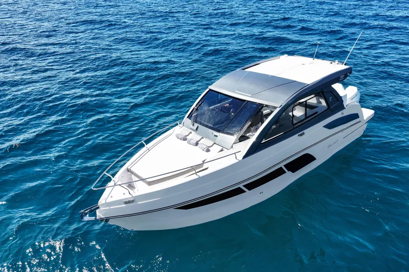 Slide: The Image of 2025 VALIATT YACHTS 380 Bowrider cruising on clear blue ocean waters. - 1
