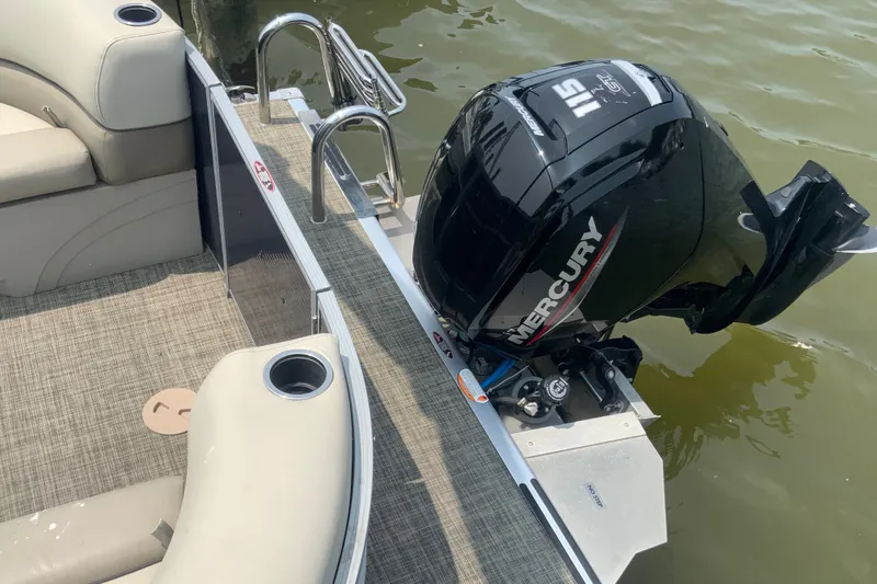 Slide: The Image of 2023 Cypress Cay Seabreeze 232 boat with Mercury 115 engine, beige seating, and cup holders. - 8