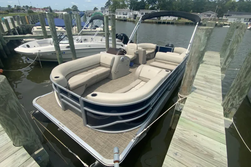 Slide: The Image of 2023 Cypress Cay Seabreeze 232 pontoon boat docked at a marina. - 3