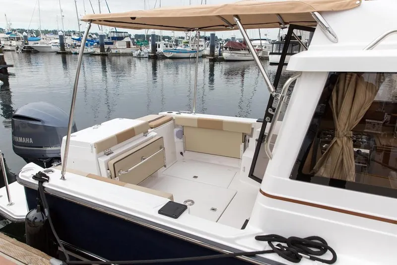 Slide: The Image of Manufacturer Provided Image: 2019 Ranger Tugs R-27 boat with spacious deck and Yamaha outboard motor. - 11