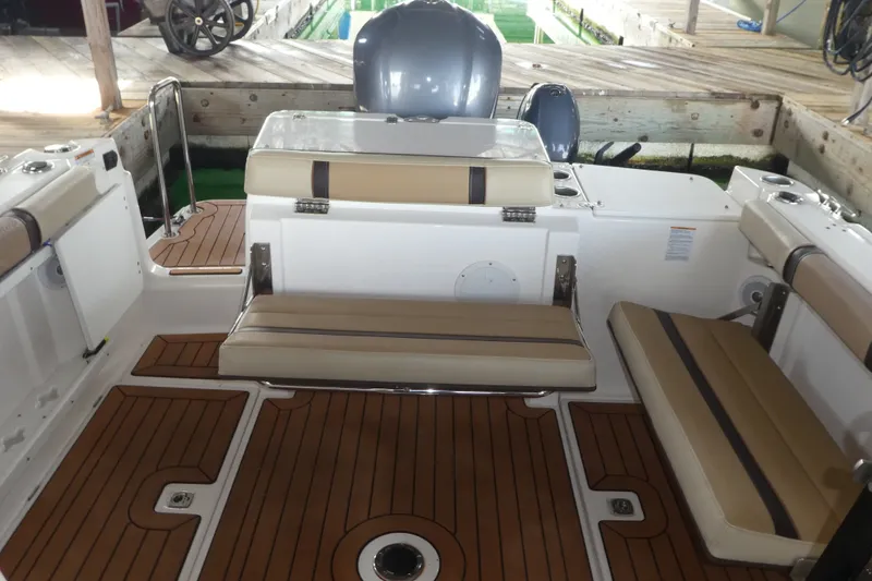 Slide: The Image of 2019 Ranger Tugs R-27 boat interior with cushioned seating and teak flooring. - 48