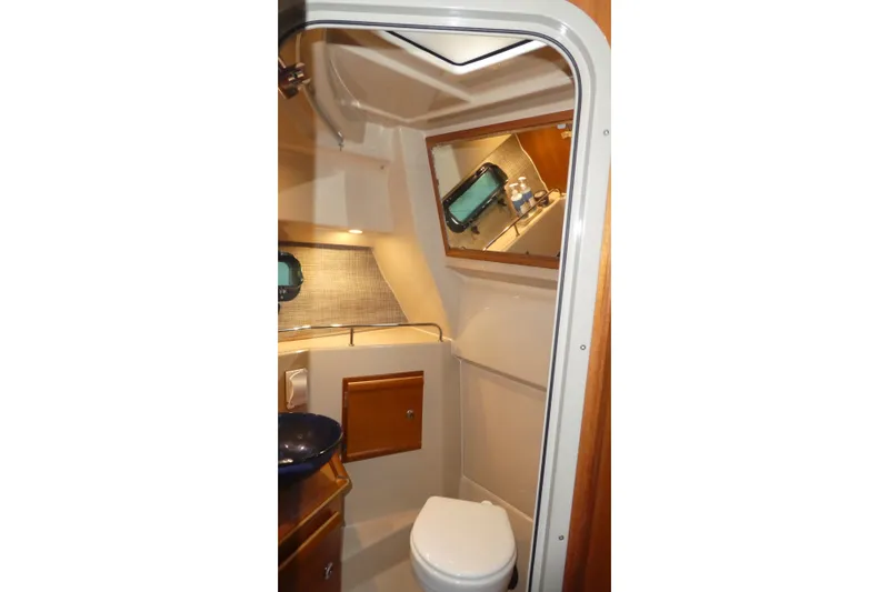 Slide: The Image of 2019 Ranger Tugs R-27 boat bathroom interior with sink and toilet. - 42