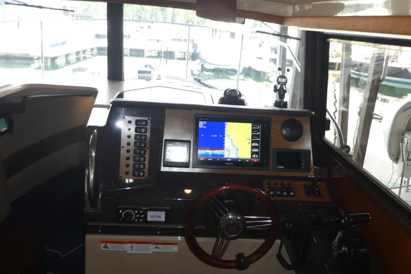 Slide: The Image of Interior helm of 2019 Ranger Tugs R-27 with navigation display and controls. - 28