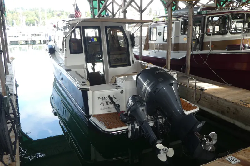 Slide: The Image of 2019 Ranger Tugs R-27 boat docked with Yamaha outboard motor. - 0