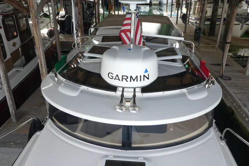 Slide: The Image of 2019 Ranger Tugs R-27 boat with Garmin equipment, docked under a wooden shelter. - 4