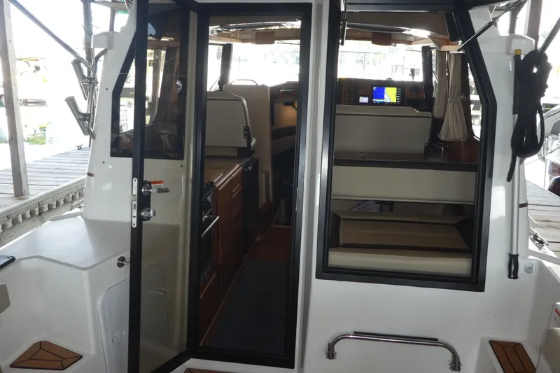 Slide: The Image of 2019 Ranger Tugs R-27 interior view with seating and navigation equipment. - 55