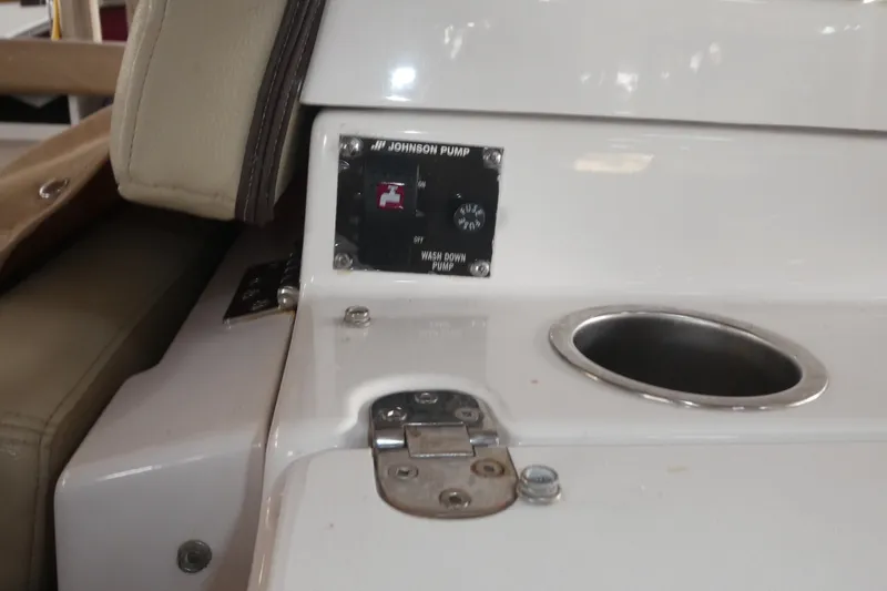 Slide: The Image of 2019 Ranger Tugs R-27 boat interior with Johnson pump control panel and cup holder. - 54