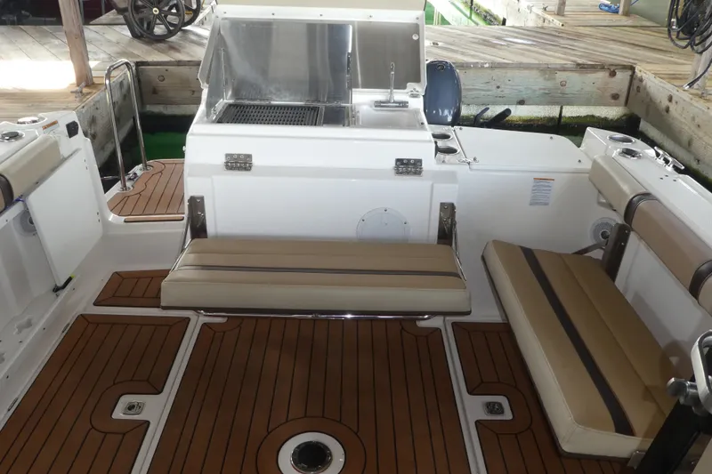 Slide: The Image of 2019 Ranger Tugs R-27 boat interior with seating and wooden deck. - 49