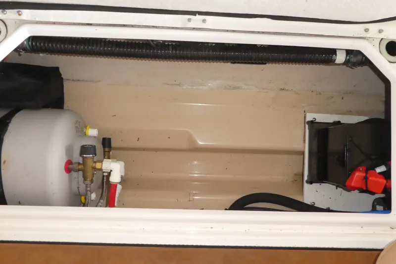 Slide: The Image of 2019 Ranger Tugs R-27 interior compartment with water heater and equipment. - 52