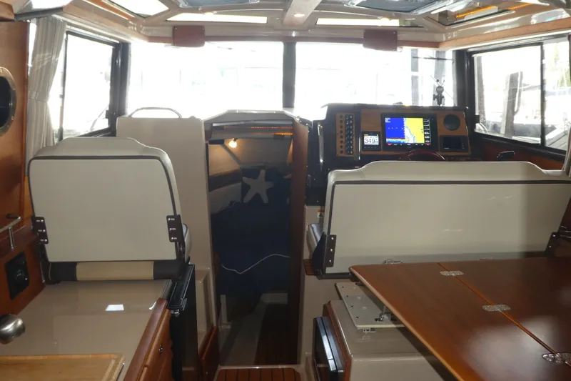 Slide: The Image of Interior of 2019 Ranger Tugs R-27 boat with navigation equipment and seating area. - 37