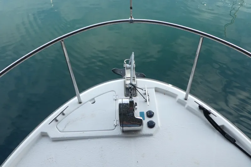 Slide: The Image of Bow of 2019 Ranger Tugs R-27 boat with anchor and calm water. - 8