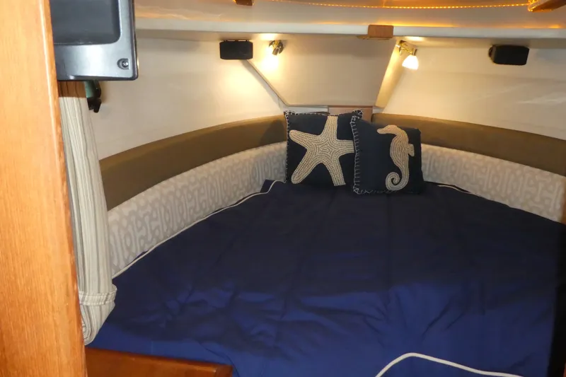 Slide: The Image of Cozy cabin interior of 2019 Ranger Tugs R-27 with nautical-themed pillows. - 39